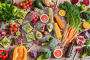 Healthy vegan food. Sandwiches and fresh vegetables on wooden background. Detox diet. Different colorful fresh juices. top view