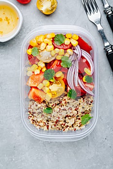 Healthy vegan meal prep containers with quinoa and fresh vegetables