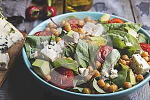 Healthy vegan salad with avocado ,beet leaves ,chickpea, broccoli ,tomato,blue cheese