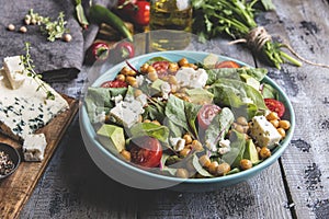 Healthy vegan salad with avocado ,beet leaves ,chickpea, broccoli ,tomato,blue cheese