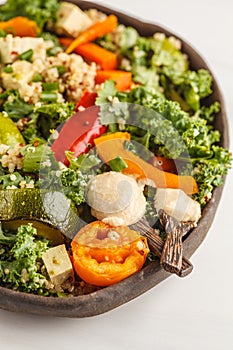 Healthy vegan salad with roasted vegetables, tahini, quinoa and