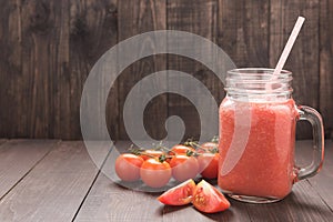 Healthy vegetable. Glass of red tomato juice on wooden table