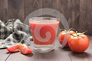 Healthy vegetable. Glass of red tomato juice on wooden table