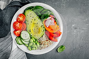 Healthy vegetable lunch Buddha bowl. Avocado, quinoa, tomatoes, cucumbers, radishes, spinach, carrots, paprika and edamame beans s