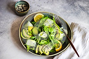 Healthy vegetable salad with aragula and avocado