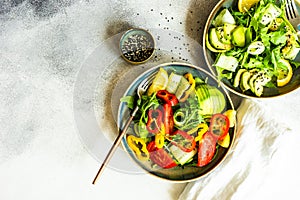 Healthy vegetable salad with aragula and avocado