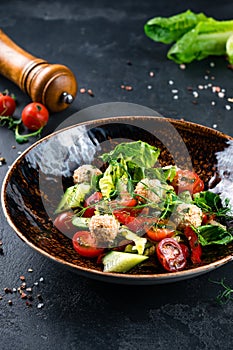 Healthy vegetable salad of fresh tomato, cucumber, lettuce on plate. Diet menu