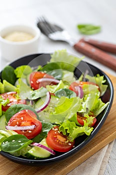 Healthy vegetable salad from fresh vegetables of tomato, spinach, cucumber, lettuce and sesame