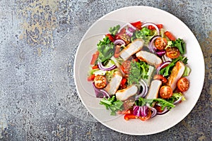 Vegetable salad with grilled chicken breast, fresh lettuce, cherry tomatoes, red onion and pepper