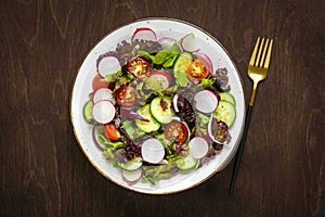 Healthy vegetable salad in white bowl