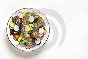 Healthy vegetable salad in white bowl