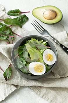 Healthy vegetarian breakfast bowls with salad, avocado and egg, top view. Clean eating, diet food concept