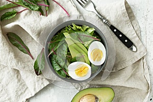 Healthy vegetarian breakfast bowls with salad, avocado and egg, top view. Clean eating, diet food concept
