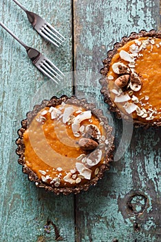 Healthy vegetarian diet. Tasty pumpkin tarts decorated with almo