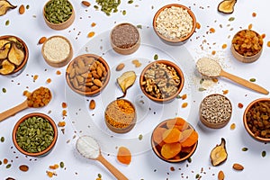 Healthy vegetarian food concept. Assortment of dried fruits, nuts and seeds on white background. Top view. Mixed nuts set closeup.