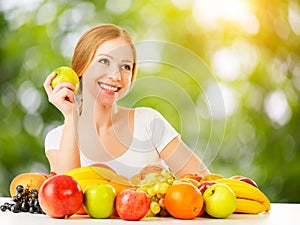 Healthy vegetarian food. happy woman eating apple in summer