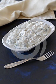 Healthy vegetarian food, purslane salad with yoghurt on dark background