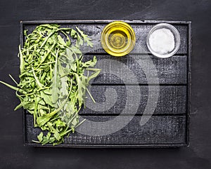 Healthy vegetarian foods green salad of cucumber, spinach and arugula with oil and salt wooden tray place for text on wooden