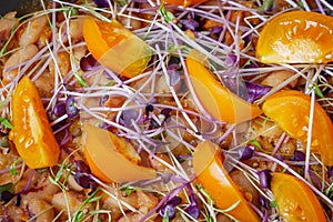 Healthy vegetarian foods with yellow tomatoes, beans and microgreens.