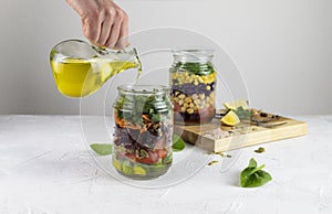 Healthy vegetarian Homemade Mason Jar fresh Salad with Chickpea and Veggies on a light background.Diet, Detox, Clean Eating, Vegan