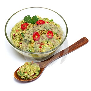 Healthy vegetarian organic guacamole Mexican dip sauce served in glass bowl with nachos or tortilla chips isolated on