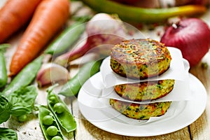 Healthy vegetarian patties made from potatoes, carrots, onions, green peas, herbs and spices