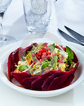 Healthy vegetarian salad, roasted root vegetables, and pomegranate seeds.