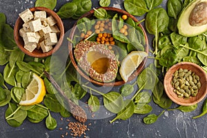 Healthy vegetarian salad with tofu, chickpea, avocado and sunflower seeds. Healthy vegan food concept. Dark background, top