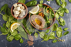 Healthy vegetarian salad with tofu, chickpea, avocado and sunflower seeds. Healthy vegan food concept. Dark background, top