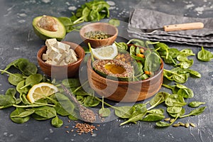 Healthy vegetarian salad with tofu, chickpea, avocado and sunflower seeds. Healthy vegan food concept. Dark background, copy