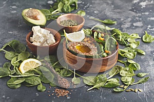 Healthy vegetarian salad with tofu, chickpea, avocado and sunflower seeds. Healthy vegan food concept. Dark background, copy