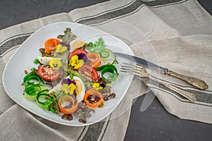 Healthy vegetarian summer salad with edible flowers