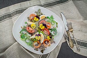 Healthy vegetarian summer salad with edible flowers