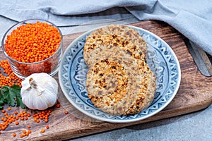 Healthy vegetarian or vegan food, meat free burger made from orange lentils legumes