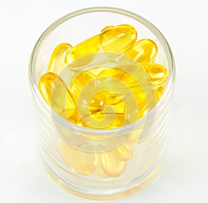 Healthy vitamin glass : yellow oil pills in translucent glass