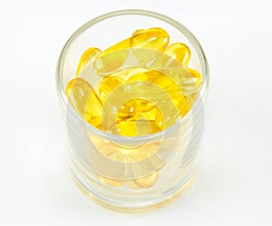 Healthy vitamin glass : yellow oil pills in translucent glass