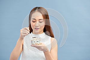 Healthy Weight Loss Food.  Young woman eating yoghurt, raisins and oatmeal