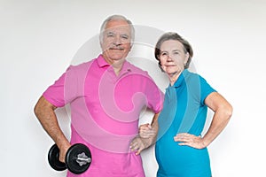 Healthy white fit smiling happy senior male female couple stand and posing indoors, enjoy life together