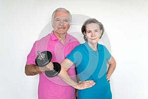 Healthy white fit smiling happy senior male female couple stand and posing indoors, enjoy life together