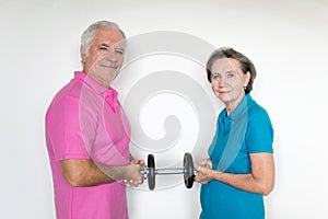 Healthy white fit smiling happy senior male female couple stand and posing indoors, enjoy life together