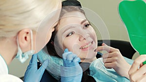 Healthy white woman teeth and dentist mouth mirror closeup