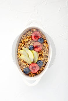 Healthy whole grain breakfast. Baked granola from oatmeal flakes in caramel with fresh berries and fruits of cherries