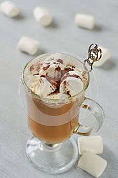 Healthy winter Christmas cocktail - hot cocoa drink or spiced latte with marshmallows and chocolate powder in the glass