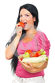 Healthy woman biting a tomato