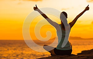 Healthy woman celebrating during a beautiful sunset. Happy and Free