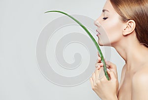 Healthy woman with clear skin and aloe leaf