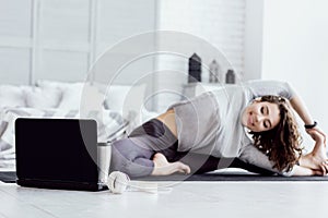 Healthy woman doing yoga workout at home