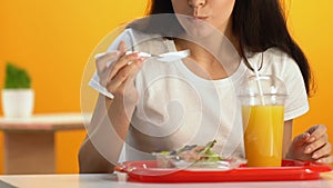 Healthy woman eating fresh vitaminized vegetable salad in cafe, wellness diet