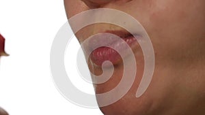 Healthy woman eating an red apple on a white background. close-up lips. healthy food and dieting concept. slow motion