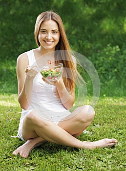 Healthy woman eating salad